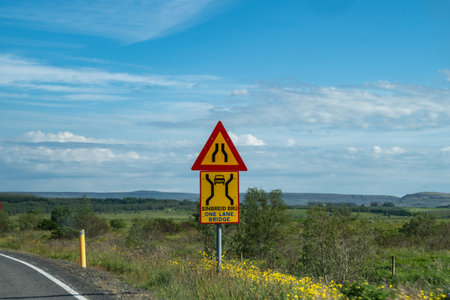 One lane bridge ahead sign along the ring road in Icelandの写真素材