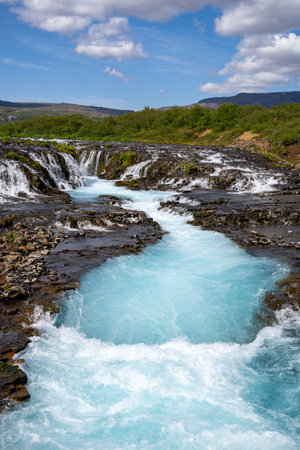 Bruarfoss waterfall on a sunny day in summer. Features beautiful teal turquoise water in Iceland along the Golden Circle areaの写真素材