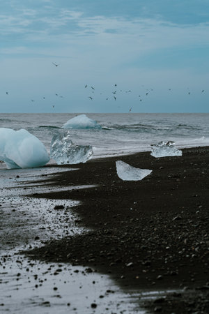 Ice glacier chunks washed ashore on Diamond Beach in Southern Icelandの写真素材
