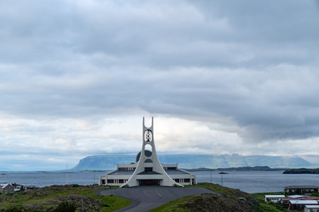 Stykkisholmur, Iceland - June 30, 2023: Modern, futuristic Stykkisholmskirkja church in Stykkisholmur, Iceland in cloudy summer dayのeditorial素材