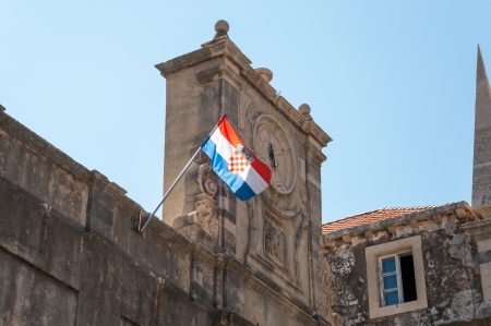 Old clock on a tower with croatian flag の写真素材