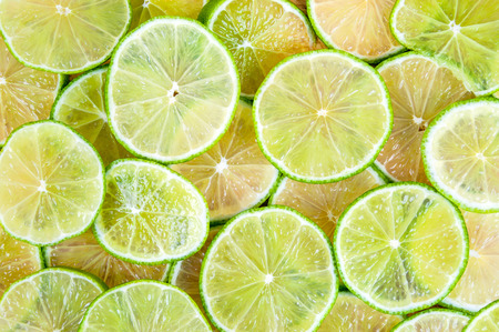 Background made of fresh ripe lime slicesの写真素材