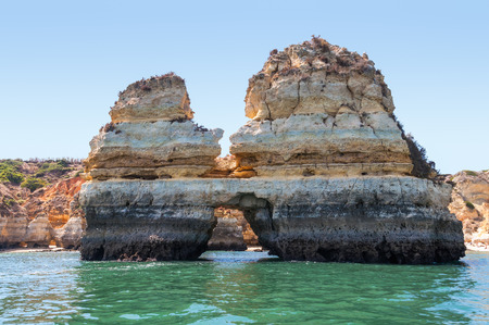 Rock formations near Lagos in Portugal seen from the waterの写真素材
