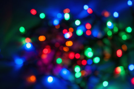 Abstract background made of colored blurred Christmas lightsの写真素材