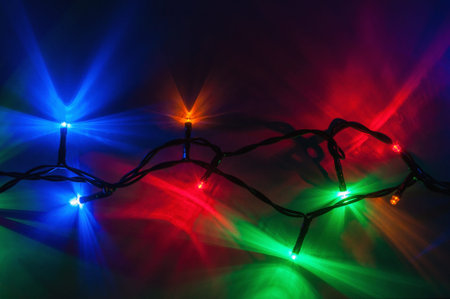 Christmas lights on dark background. Decorative garland