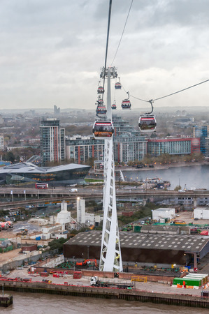 LONDON, UNITED KINGDOM - NOVEMBER 8, 2014:  Gondolas of the Emirates Air Line cable car in London on a rainy day. Thames cable car is a ten minute gondola lift link across the River Thames.のeditorial素材