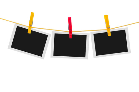 Three blank instant photos on clothesline isolated on white backgroundの写真素材