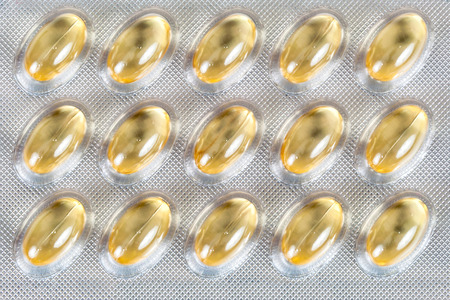 Closeup of cod liver oil capsules in a packageの写真素材
