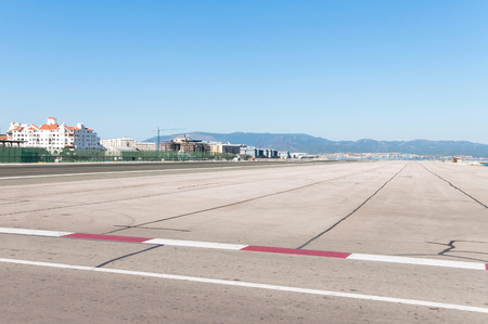 Dangerous airport runway in Gibraltar with spanish port in the backgroundの写真素材