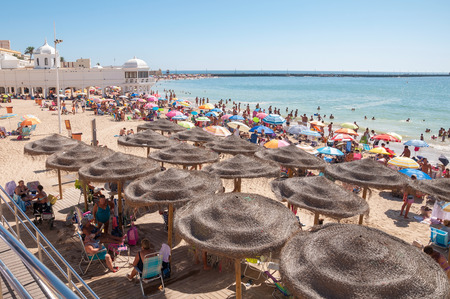 CADIZ SPAIN AUGUST 27 2014: People sunbathing on Caleta Beach small and very popular beach located in Cadiz city center.のeditorial素材