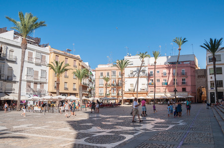 CADIZ, SPAIN - AUGUST 27, 2014: Tourists visit pavement cafes in the Plaza de la Catedral in Cadiz.のeditorial素材