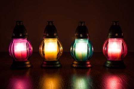 Closeup of burning votive candles in the dark