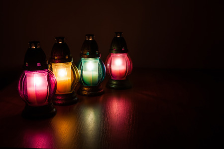 Closeup of burning votive candles in the darkの写真素材