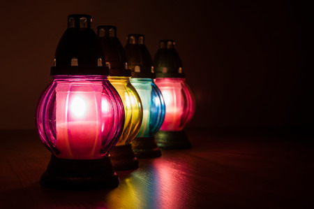 Closeup of burning votive candles in the darkの写真素材