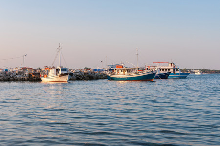 Boats at Agios Sostis port at sunset, Zakynthos, Greeceの写真素材