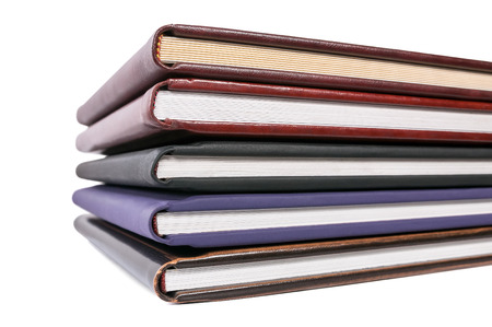 Pile of books in leather covers isolated on white background with clipping pathの写真素材