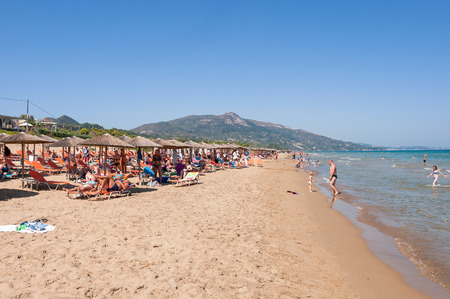 Banana beach, Zakynthos, Greece - August 31, 2015: People sunbathe on the Banana beach, one of the most famous beaches on Zakynthos Island.のeditorial素材