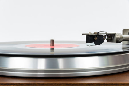 Closeup of turntable with vinyl record on white background