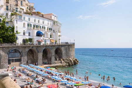 Amalfi, Italy - September 1, 2016: People sunbath on the picturesque beach of Amalfi townのeditorial素材