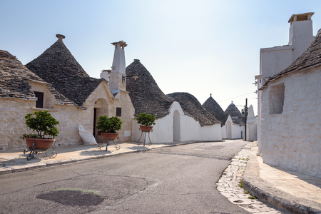 View of street in Alberobello town with famous trulli houses, Italyの写真素材