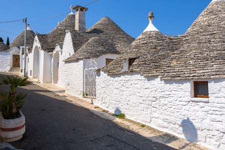 View of narrow picturesque street in Alberobello town, Apulia, Italyの写真素材
