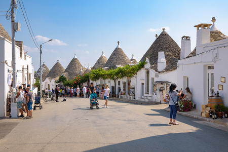 Alberobello, Italy - September 3, 2016: Tourists visit Piazza D'Annunzio in the town of trulli.のeditorial素材