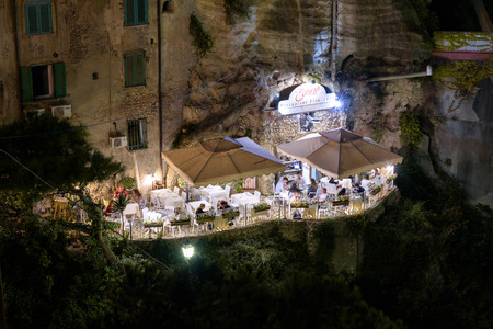 Tropea, Italy - September 06, 2016: People visit restaurant on the cliff in small town in southern Italy by nightのeditorial素材
