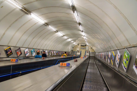 London, UK - Appril 26, 2018: Passengers use escalator to leave the underground station