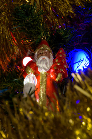 Closeup of Santa Claus figure on a Christmas tree as backgroundの写真素材