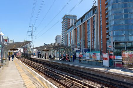 London, UK - May 1, 2018: People wait for the train on Royal Victoria DLR station in docklands district.のeditorial素材