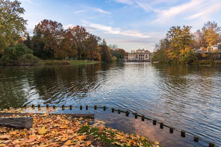 Autumn evening view of pond and palace in Royal Baths Park in Warsawのeditorial素材
