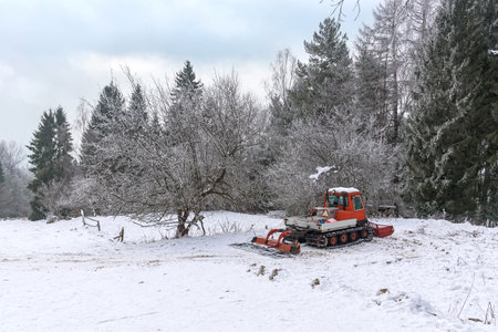 Snow groomer in a mountains at winterの写真素材