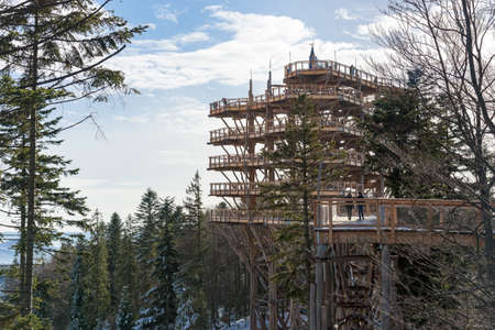 Krynica Zdroj, Poland - January 27, 2020: Tourists visit treetop observation tower at Slotwiny Arena ski stationのeditorial素材