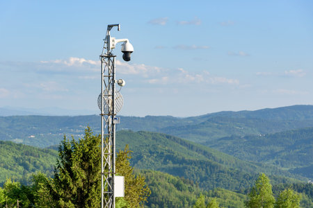 Webcam and antenna on the mast in the mountains