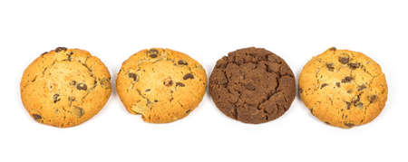 One dark chocolate chips cookie among the light ones isolated on white backgroundの写真素材