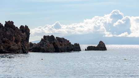 Rocky coast of Tenerife island with La Gomera island in the background. Canary Islands, Spain