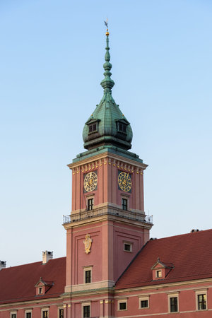 Detailed view of the Royal Castle clock tower in Warsaw's old town, showcasing its baroque...