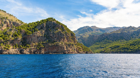 Stunning coastal cliffs and forested mountains meet the shimmering mediterranean sea near Sa Calobra...