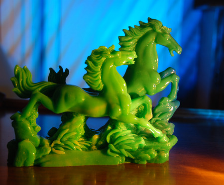 A jade statue of two horses runningの写真素材