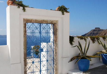 A blue wrought iron gate on the island of Santoriniの写真素材