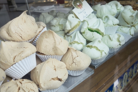 Beautiful fluffly meringues in a bakery window in Barcelonaの写真素材