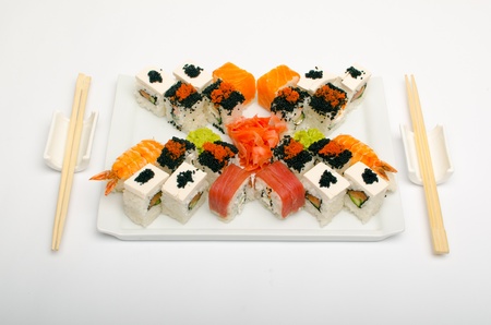 plate of sushi, tofu, eggs, salmon rods, and sticksの写真素材