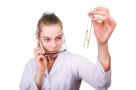 Woman looks to the germinated seed in a tube