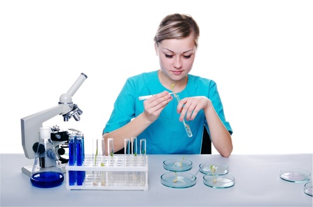 Girl researcher working with the test tubes and microscopeの写真素材