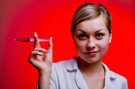 girl with a syringe with red liquidの写真素材