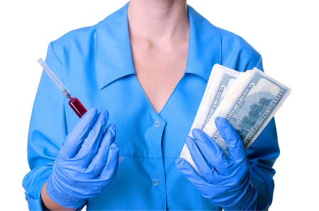 Doctor keeps the money and the red medicineの写真素材