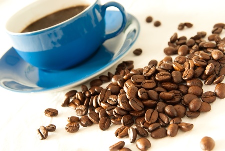 tasty coffee beans with blue cupの写真素材