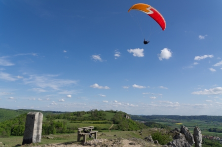 Summit with paraglider flying aboveのeditorial素材