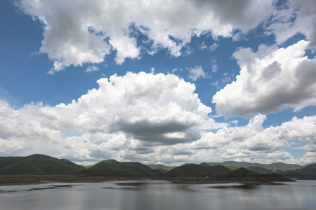 Raincloud moving on blue sky at mae kuang dam in doi saket district in chiangmai north of thailandの写真素材