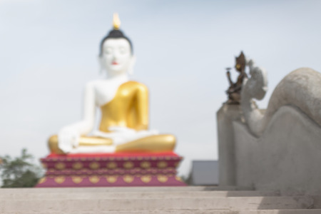 Defocus of angel and big buddha statue in chiangmai thailand temple public location blur backgroundの写真素材